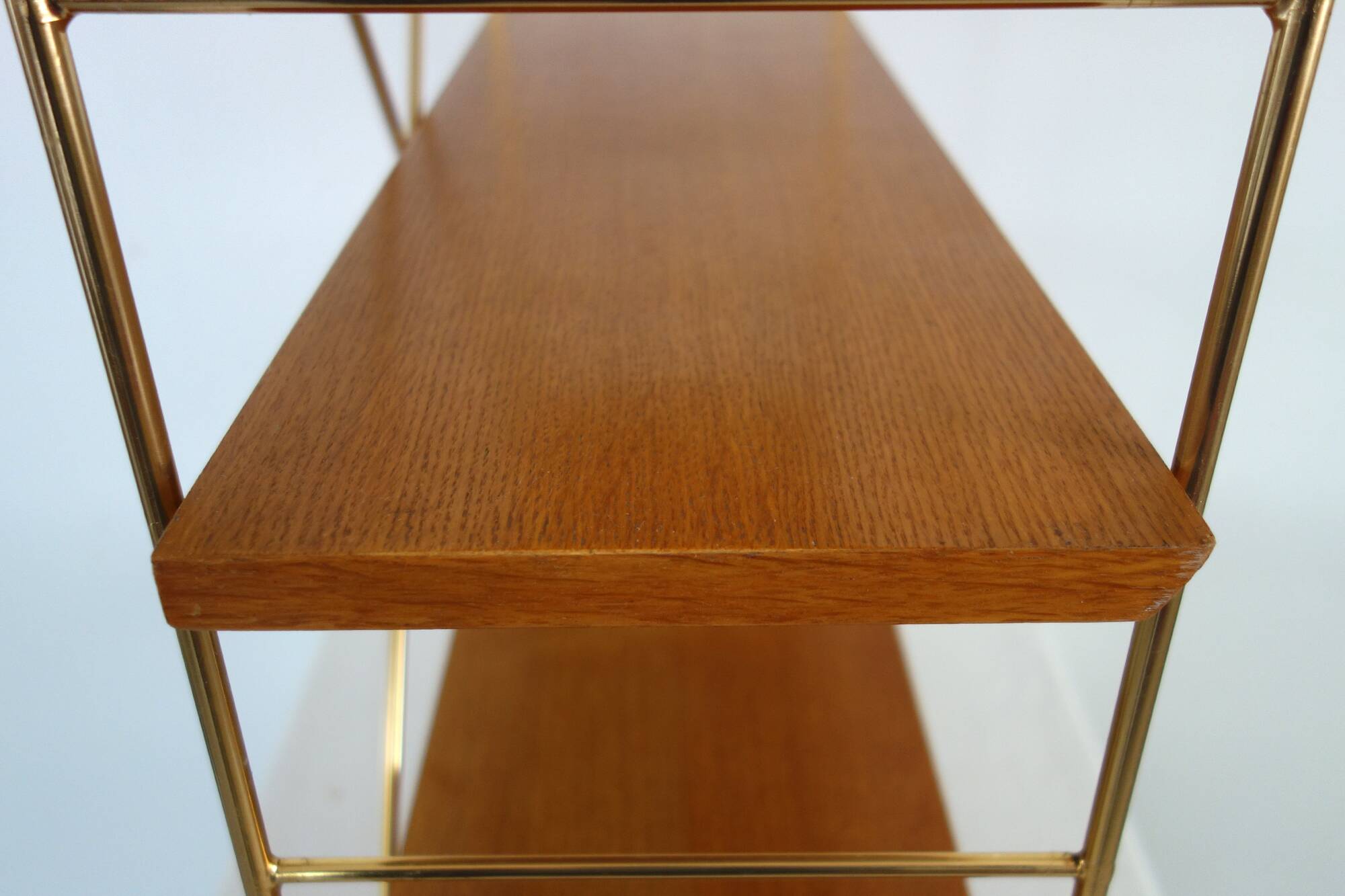 String wall shelf in gold metal and wood from the 60s