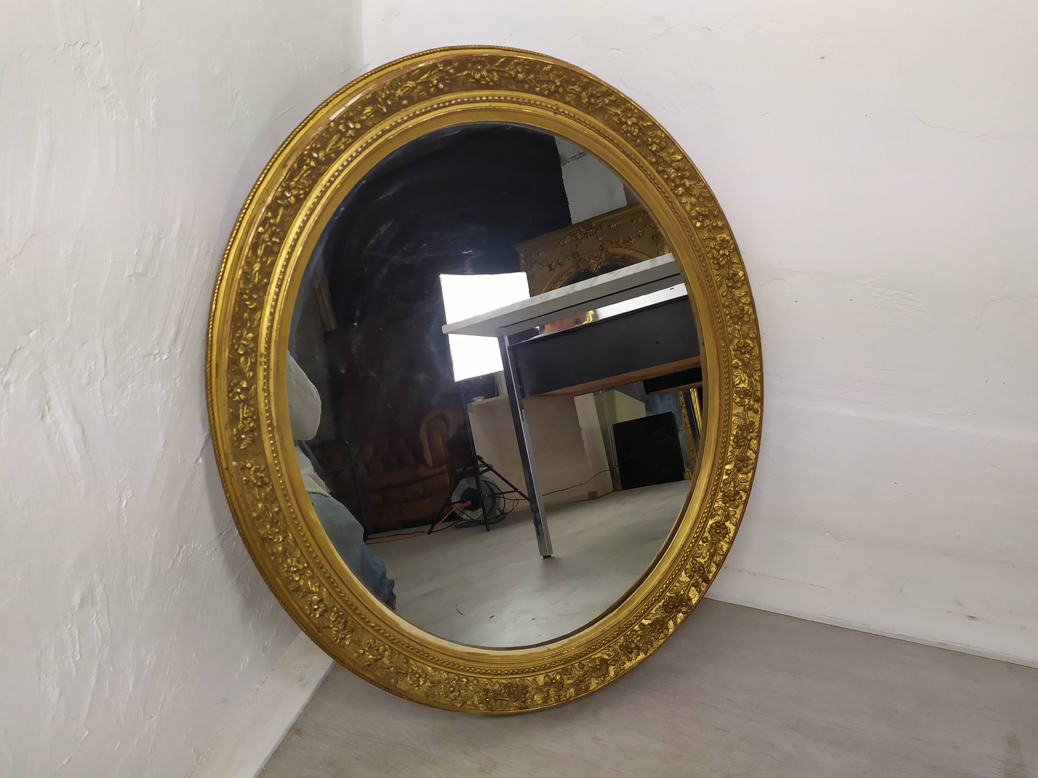 Golden oval mirror