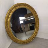 Golden oval mirror