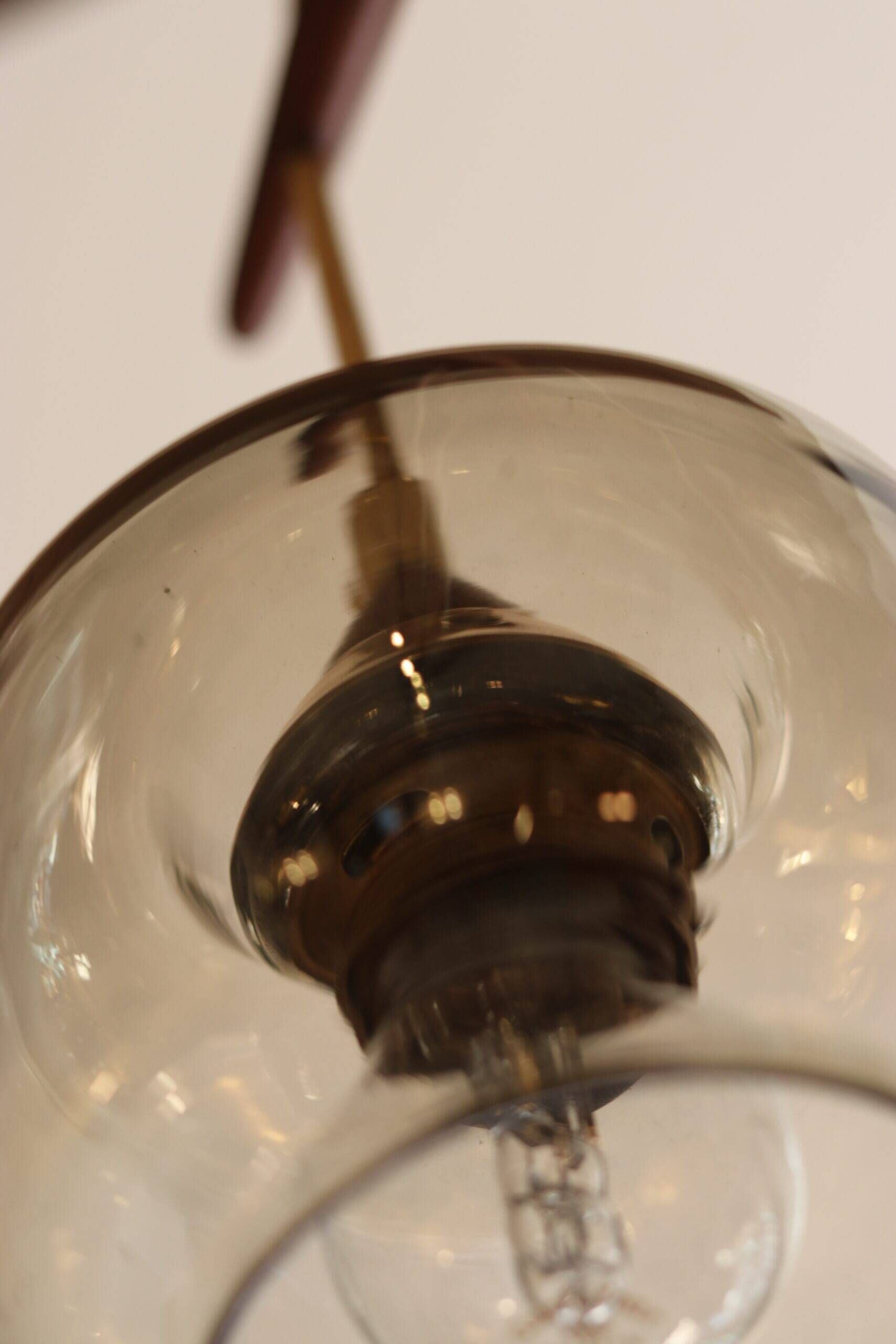 Scandinavian chandelier "Cascade" from the 1960s in brass, teak, and smoked glass.
