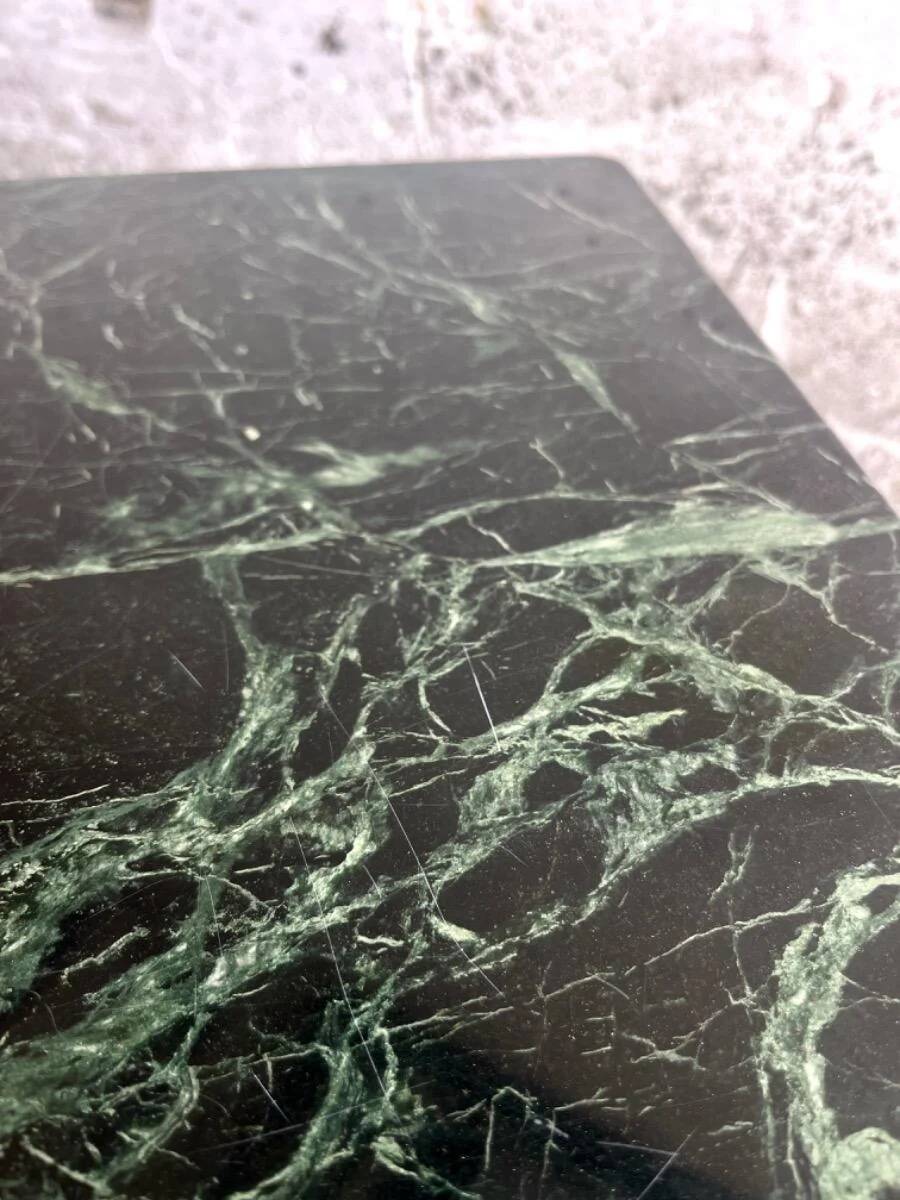 Vintage coffee table with a green marble top and gold legs.