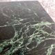 Vintage coffee table with a green marble top and gold legs.