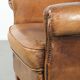 Sheepskin armchair with a beautiful vintage look and decorative nail finish