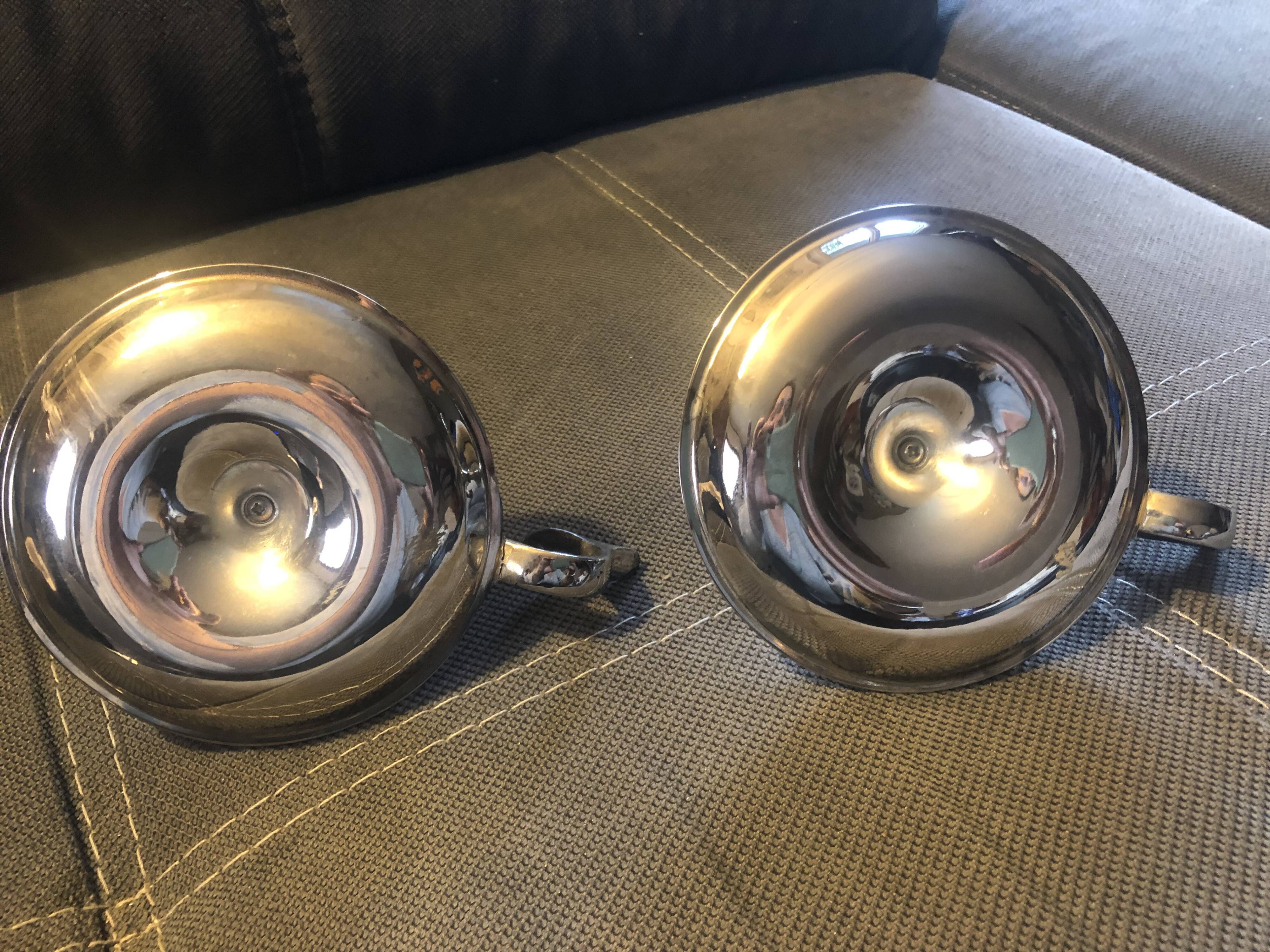 Pair of silver metal hand candle holders