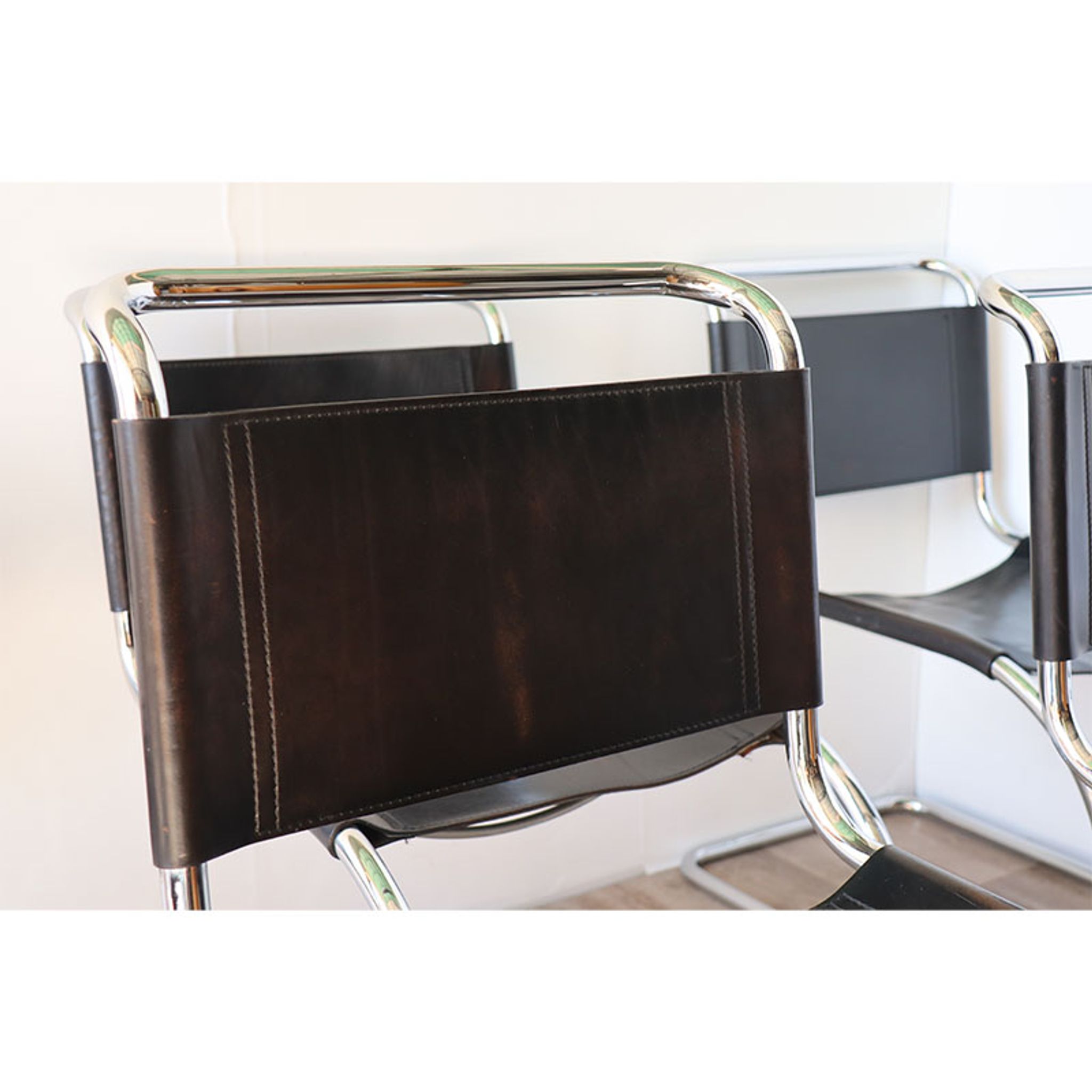 Series of 6 minimalist chairs in chrome metal and black leather around 1970