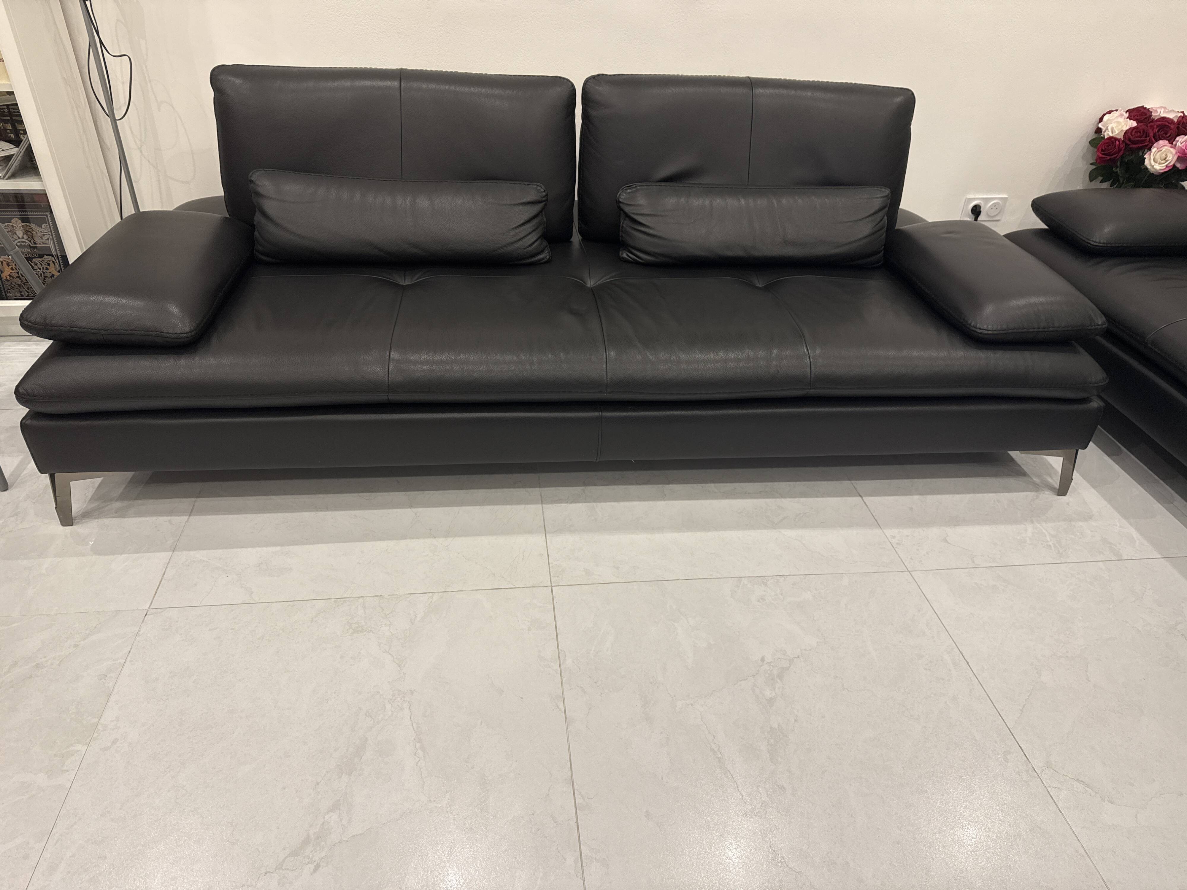 2 black leather sofas roche bobois scenario, one three-seater and one chaise longue.