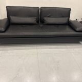 2 black leather sofas roche bobois scenario, one three-seater and one chaise longue.