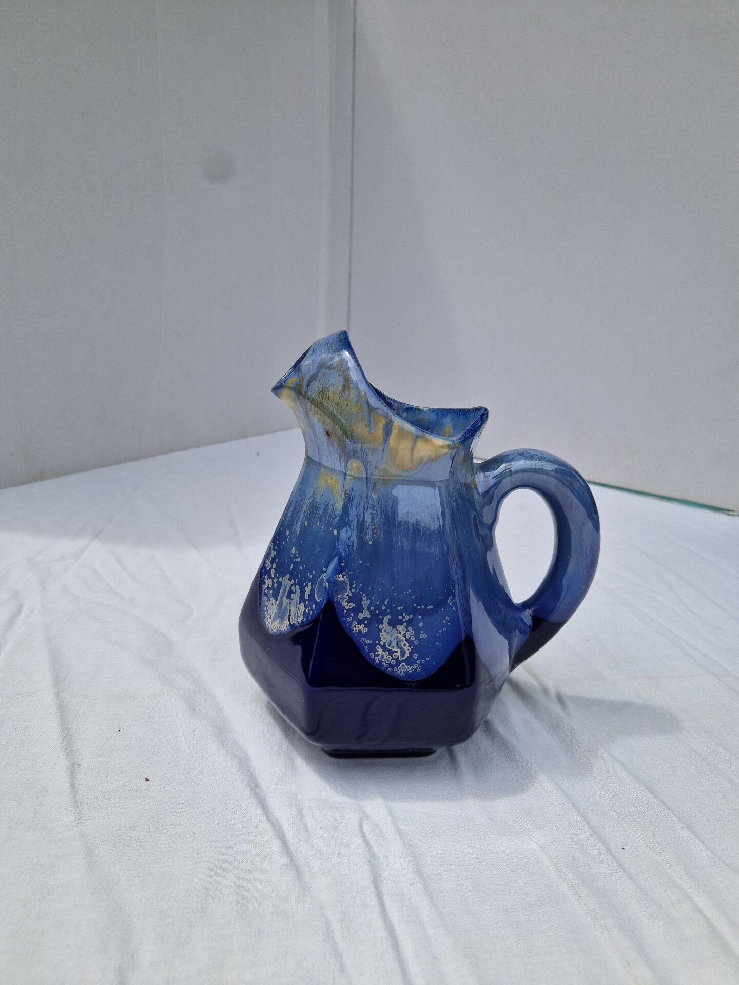Old flamed ceramic jug. Very beautiful shades of blue, 6 sides.