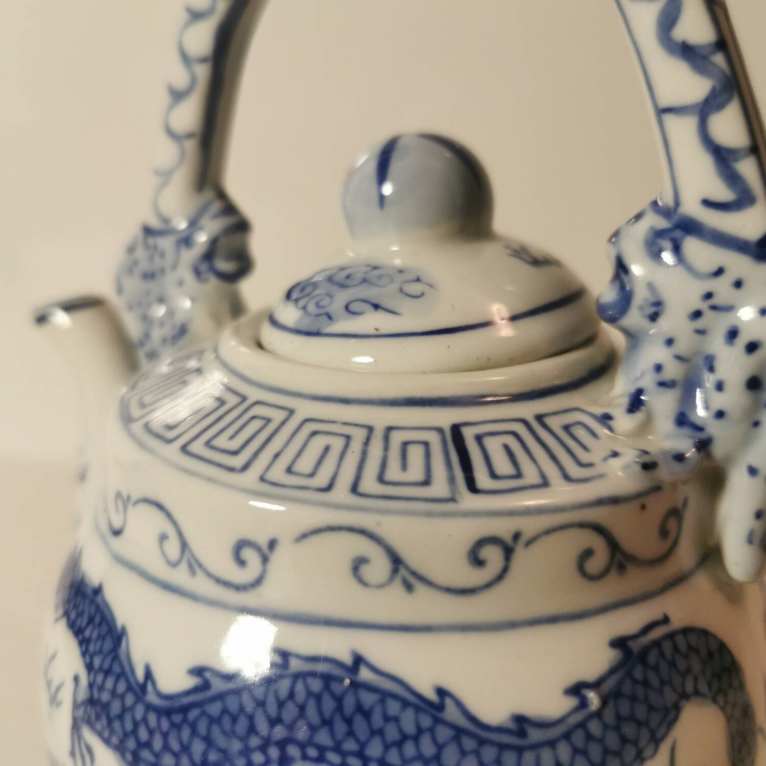 Old Chinese blue and white teapot in vintage ceramic with dragon decor