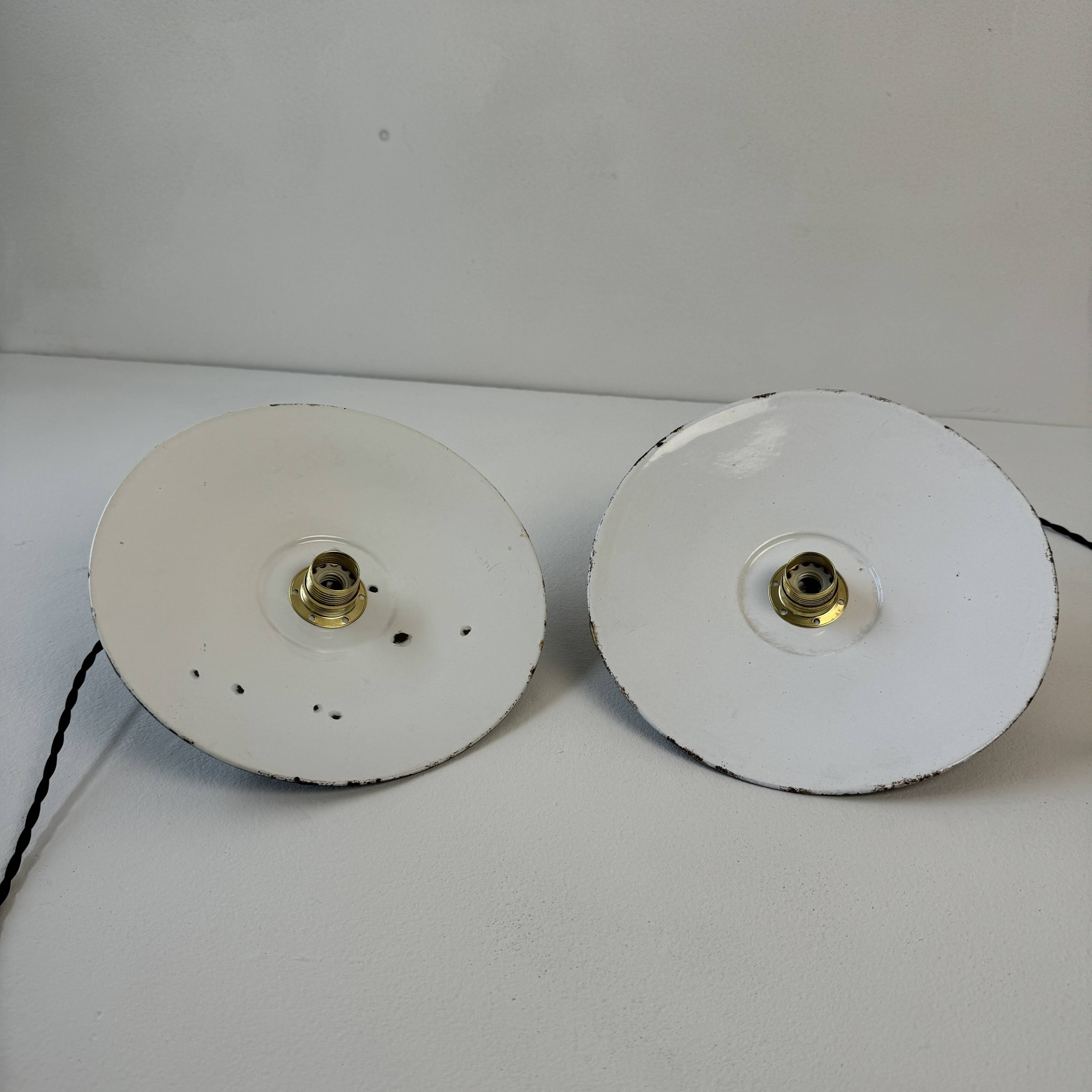Pair of old industrial black enamelled pendant lights