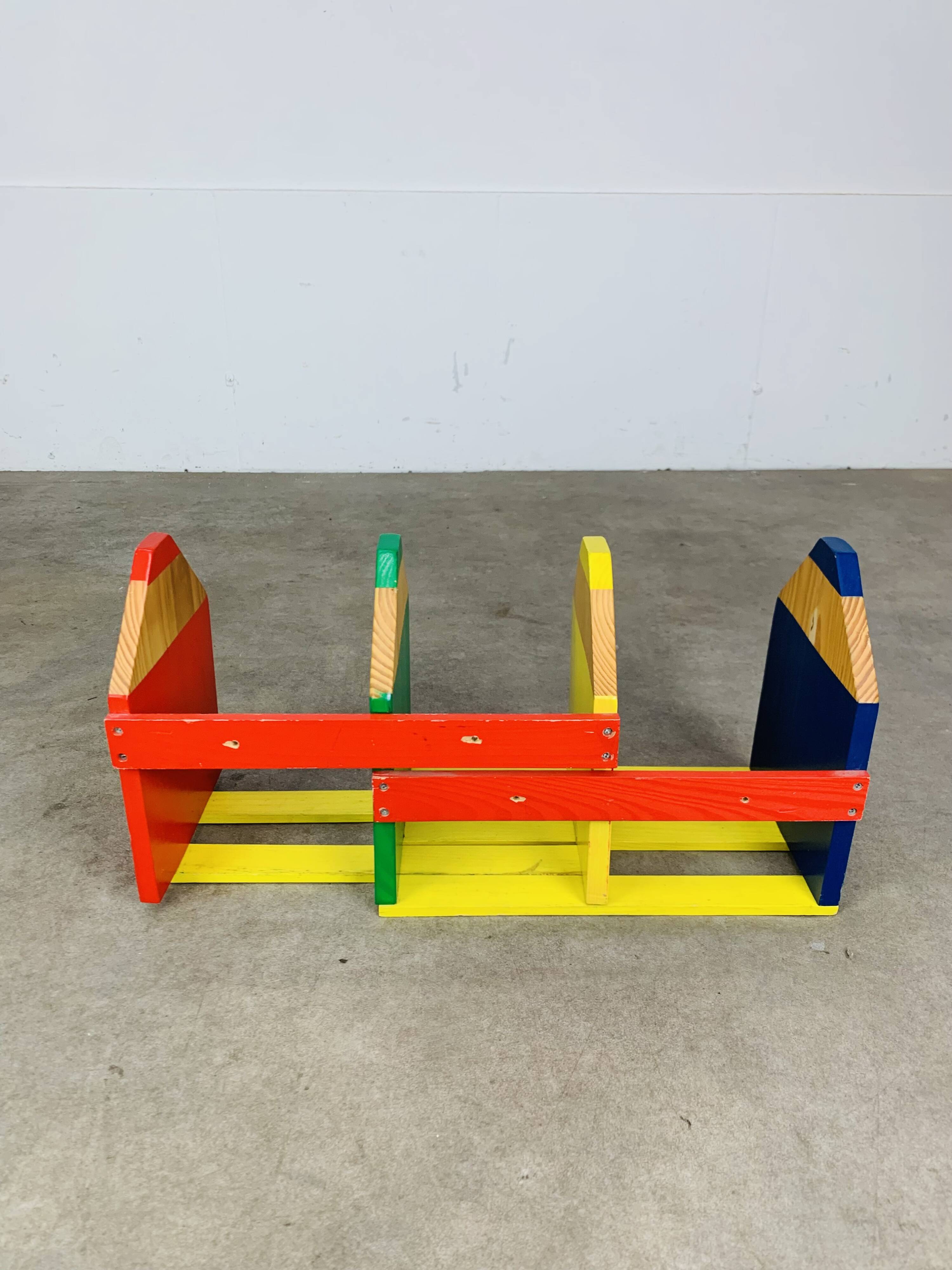 Modular wall-mounted pencil shelf in Pierre Sala style, for children.