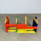Modular wall-mounted pencil shelf in Pierre Sala style, for children.