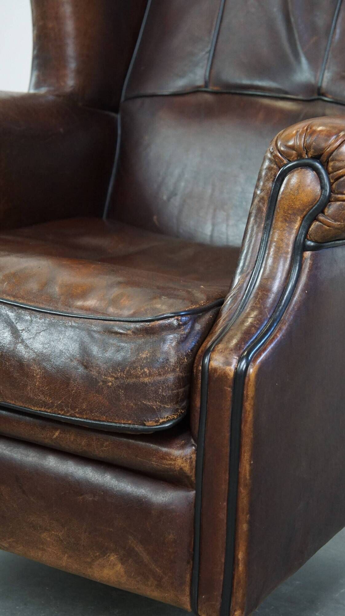 Wing chair made of sheepskin and neatly finished with black piping