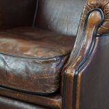 Wing chair made of sheepskin and neatly finished with black piping
