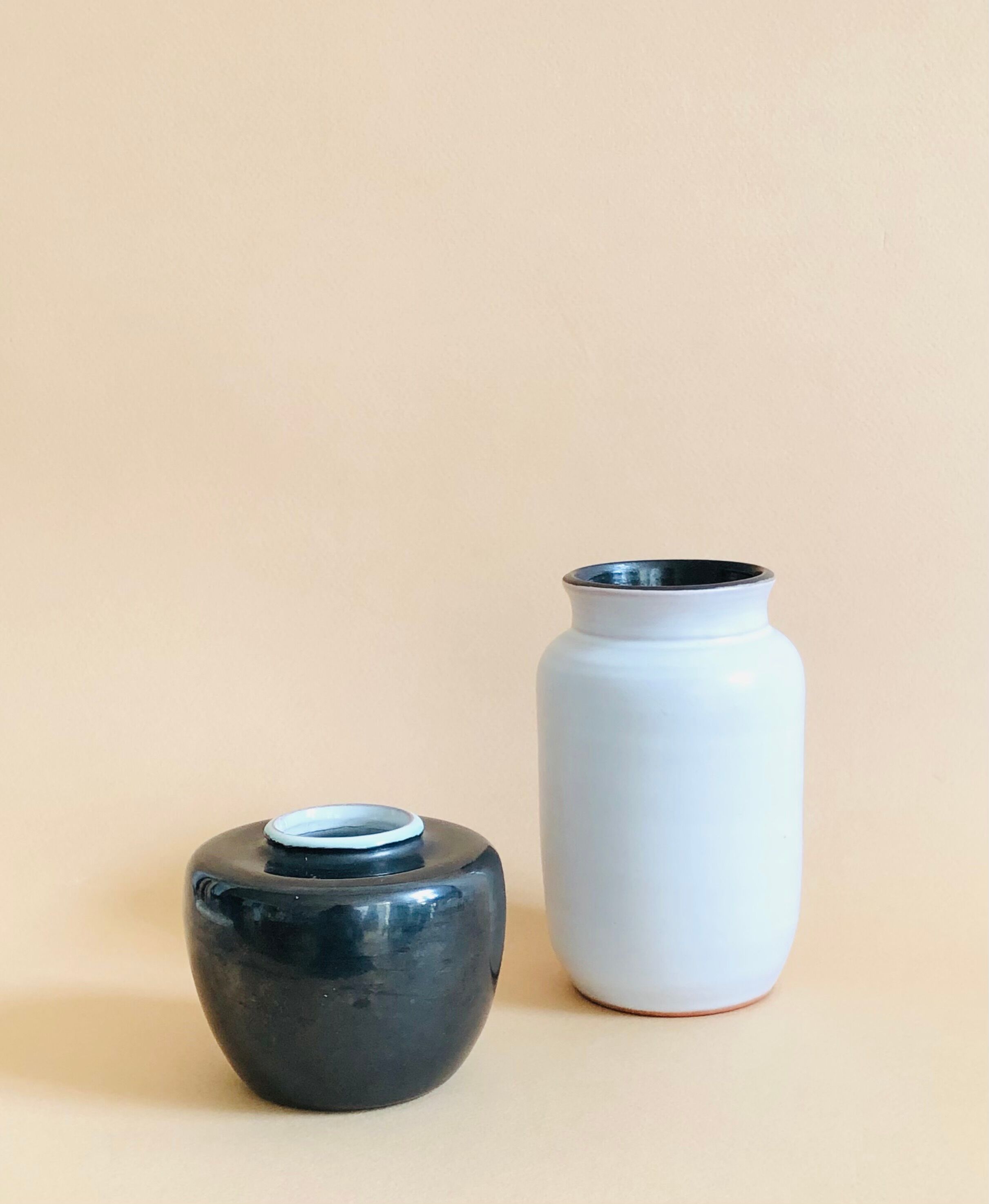Duo of small black and white ceramic vases