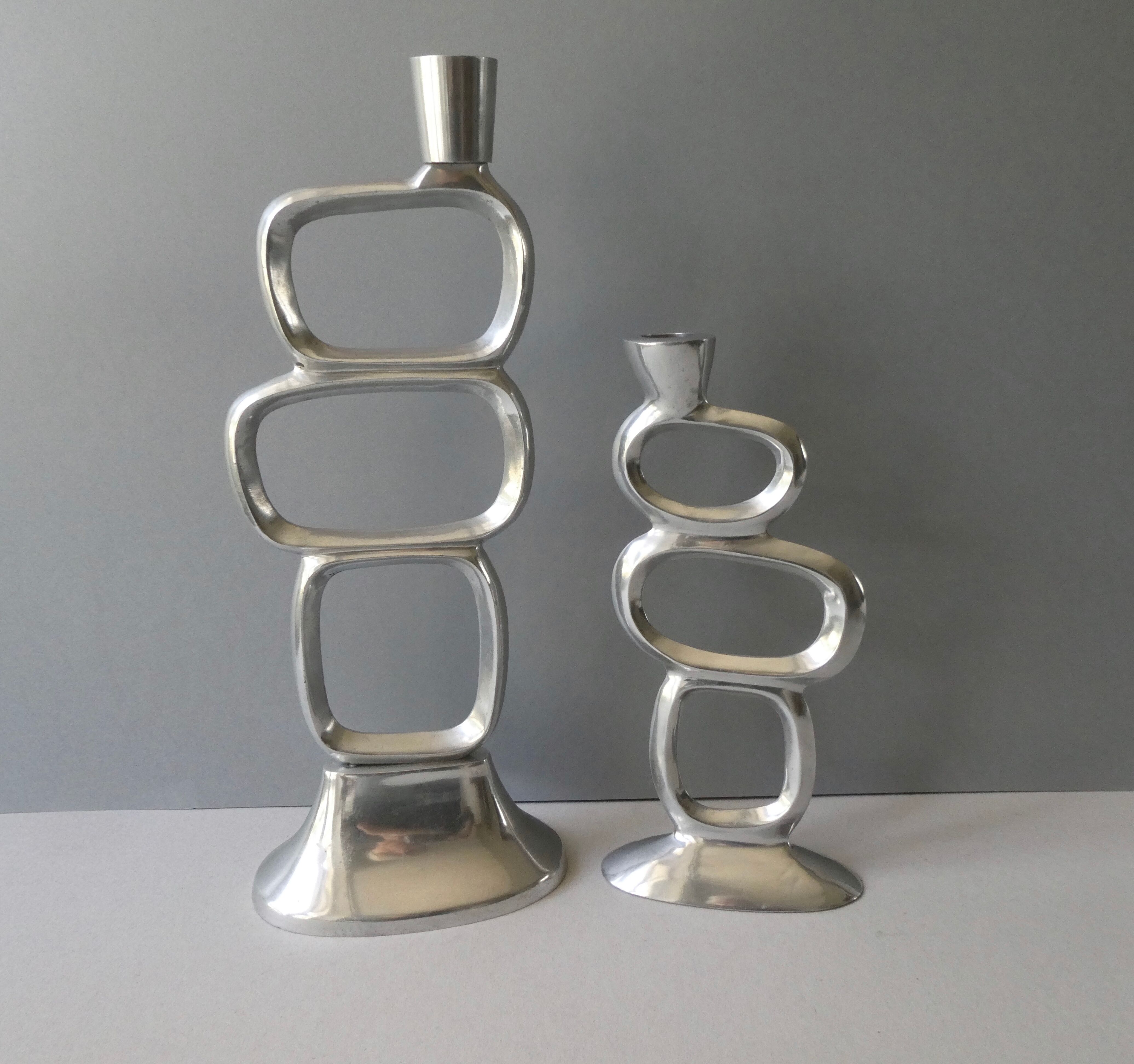 Pair of cast aluminum candle holders, design