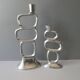 Pair of cast aluminum candle holders, design