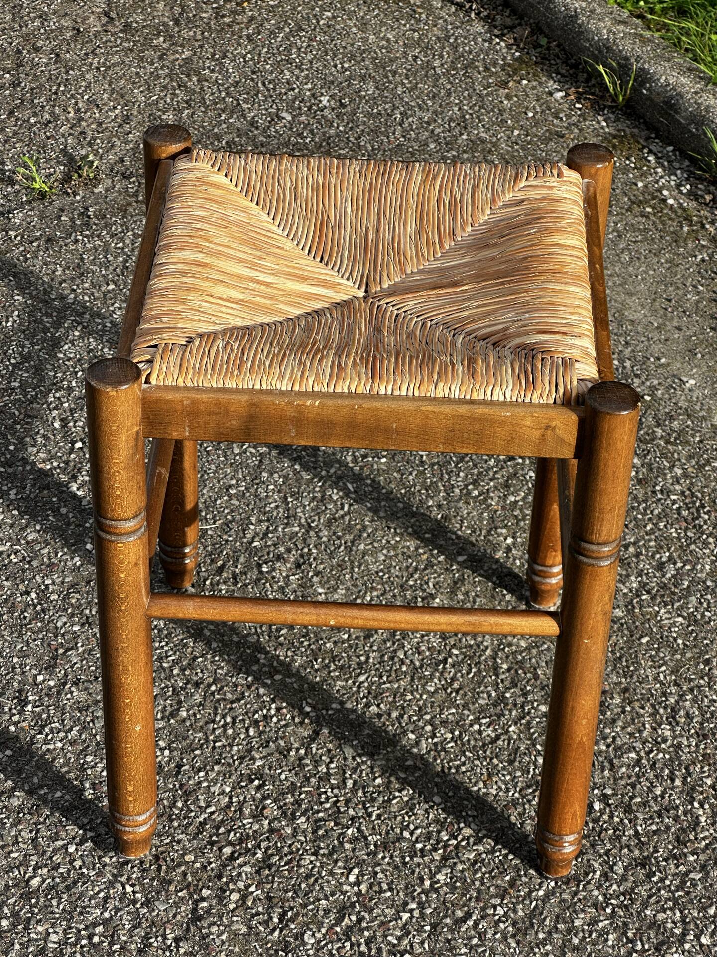 1950s turned wooden stool with a straw seat.