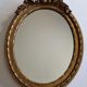 Louis xvi style oval mirror decorated with ribbons