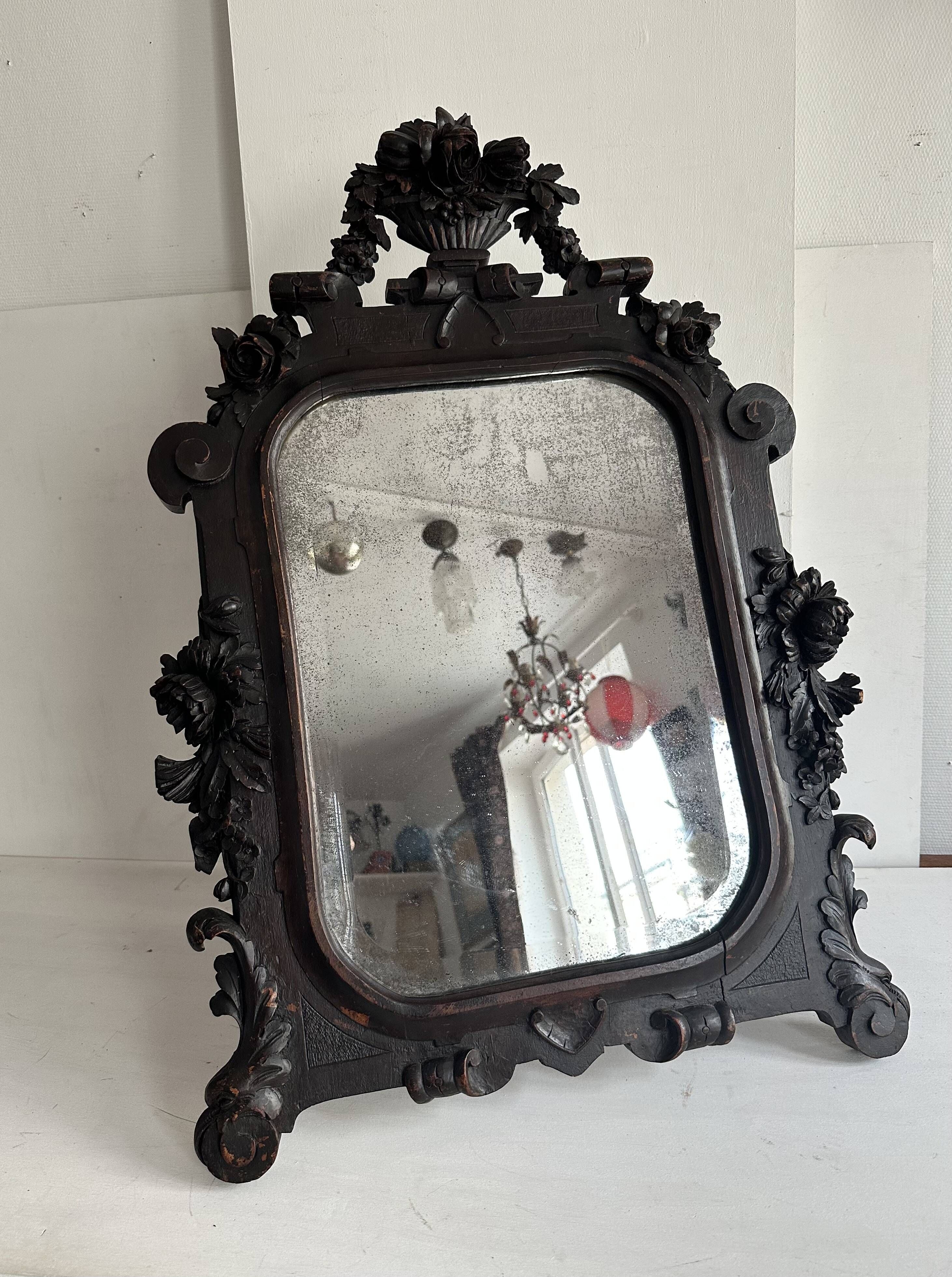 Napoleon III mirror in carved blackened wood, 19th century