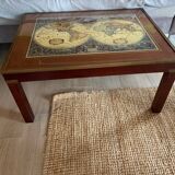 Wood and brass coffee table with a world map under glass.