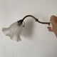 Antique swan neck wall light in brass and porcelain with a glass shade.