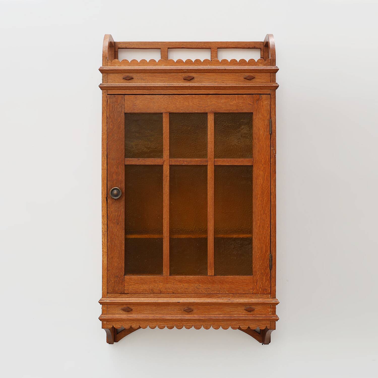 Art Deco oak wall cabinet with amber glazed door, Belgium ca. 1925