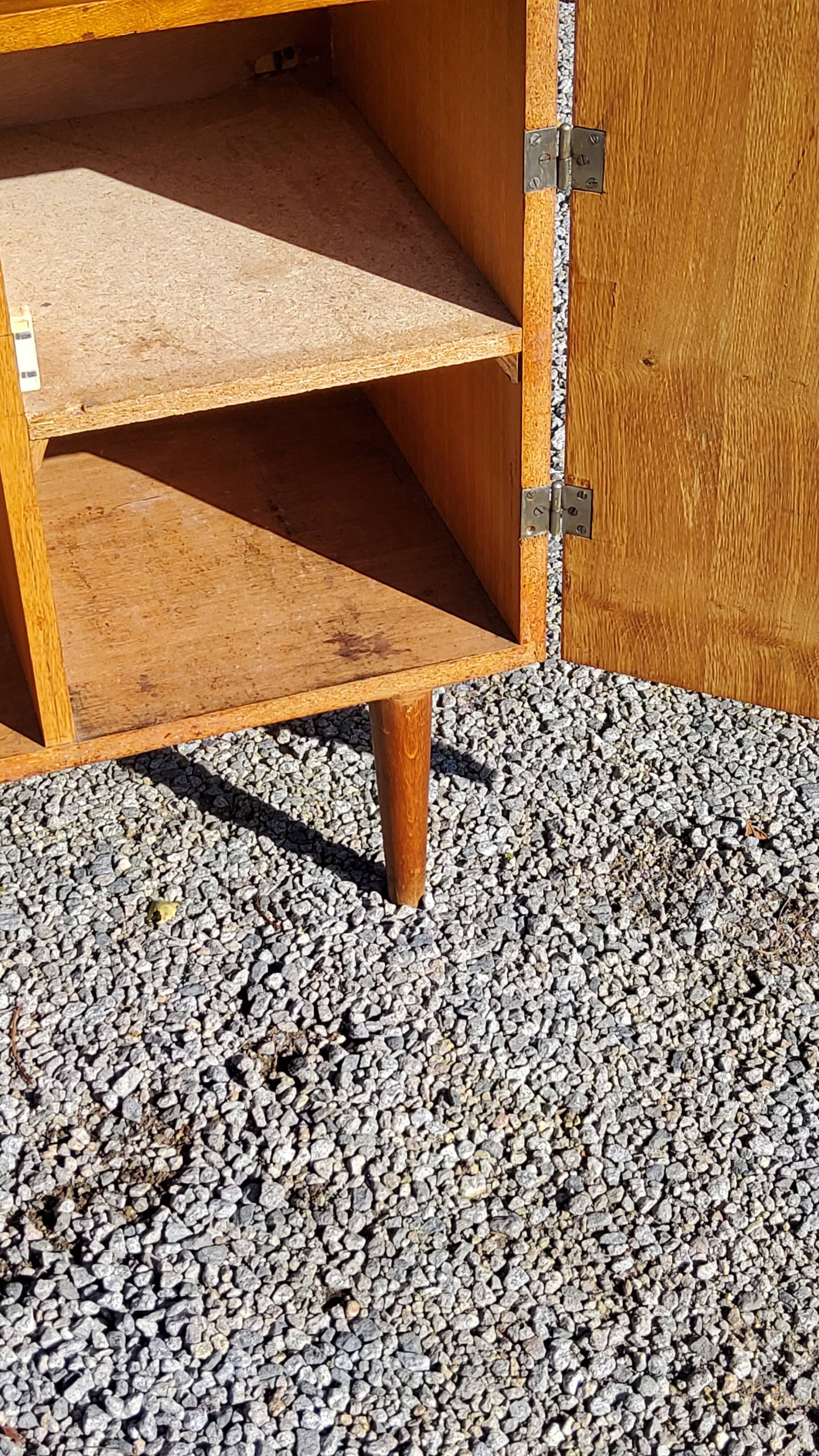 Vintage golden oak sideboard with conical legs from the 1950s