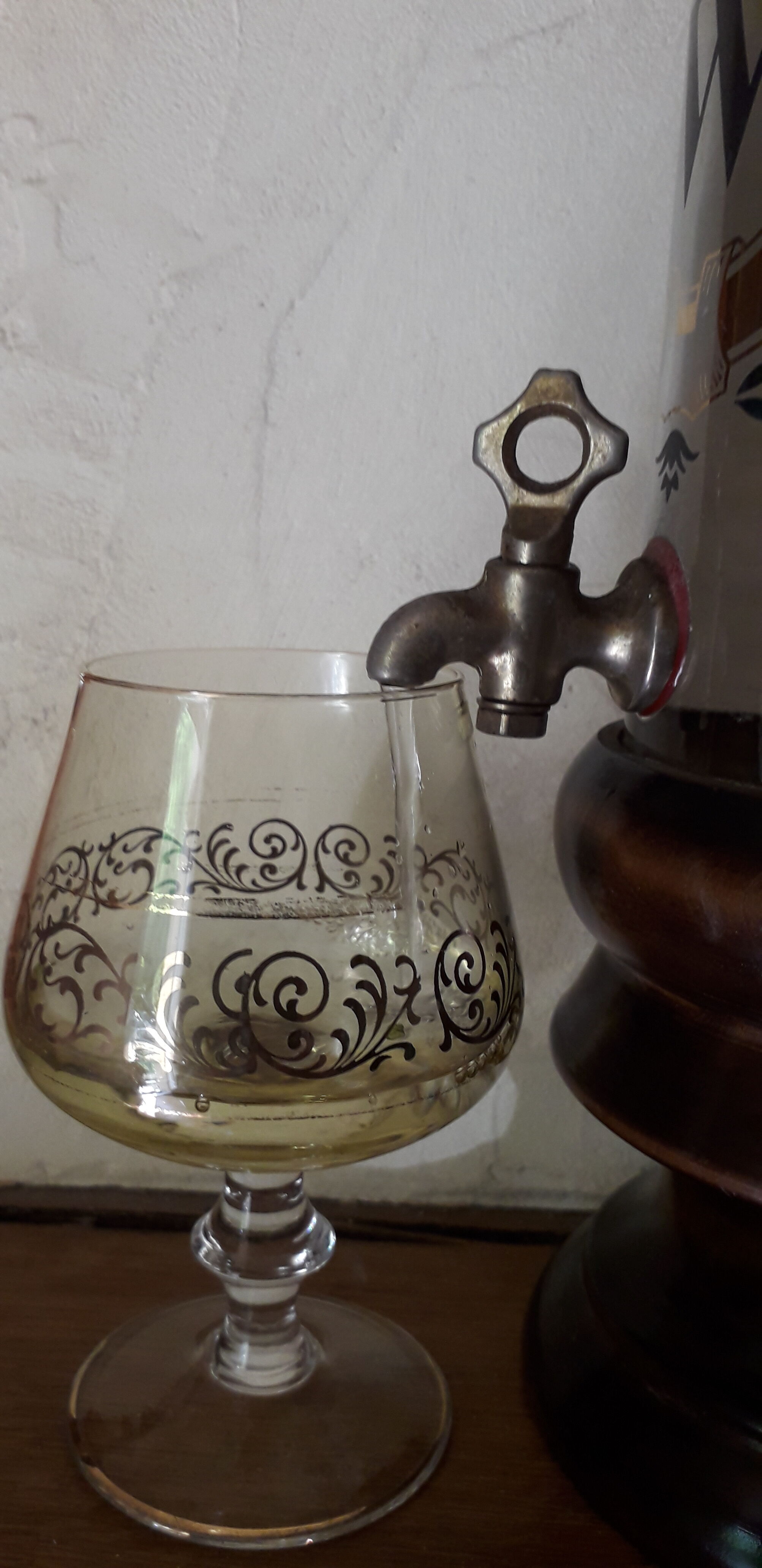 Vintage glass and wood whiskey bottle with pouring tap