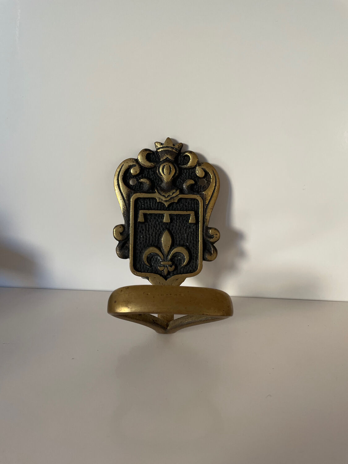 Brass hook fleur-de-lys decoration