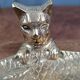 Vintage cat fish catchall in brass on a solid wood base.