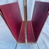 Vintage magazine rack in red skai with gold metal frame and plastic handle