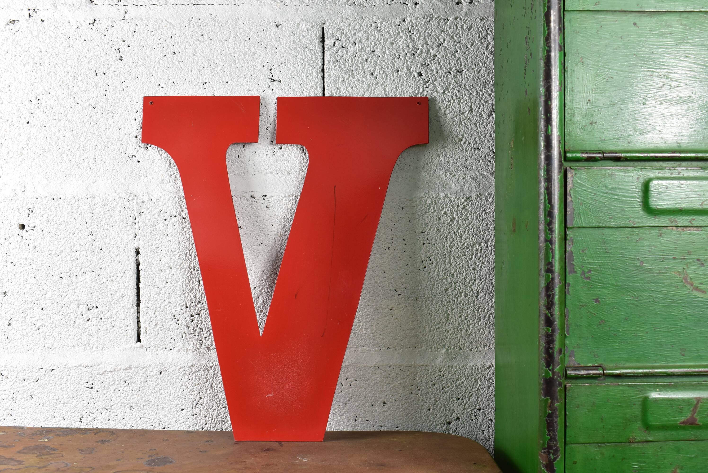 Industrial letter "V" in red metal