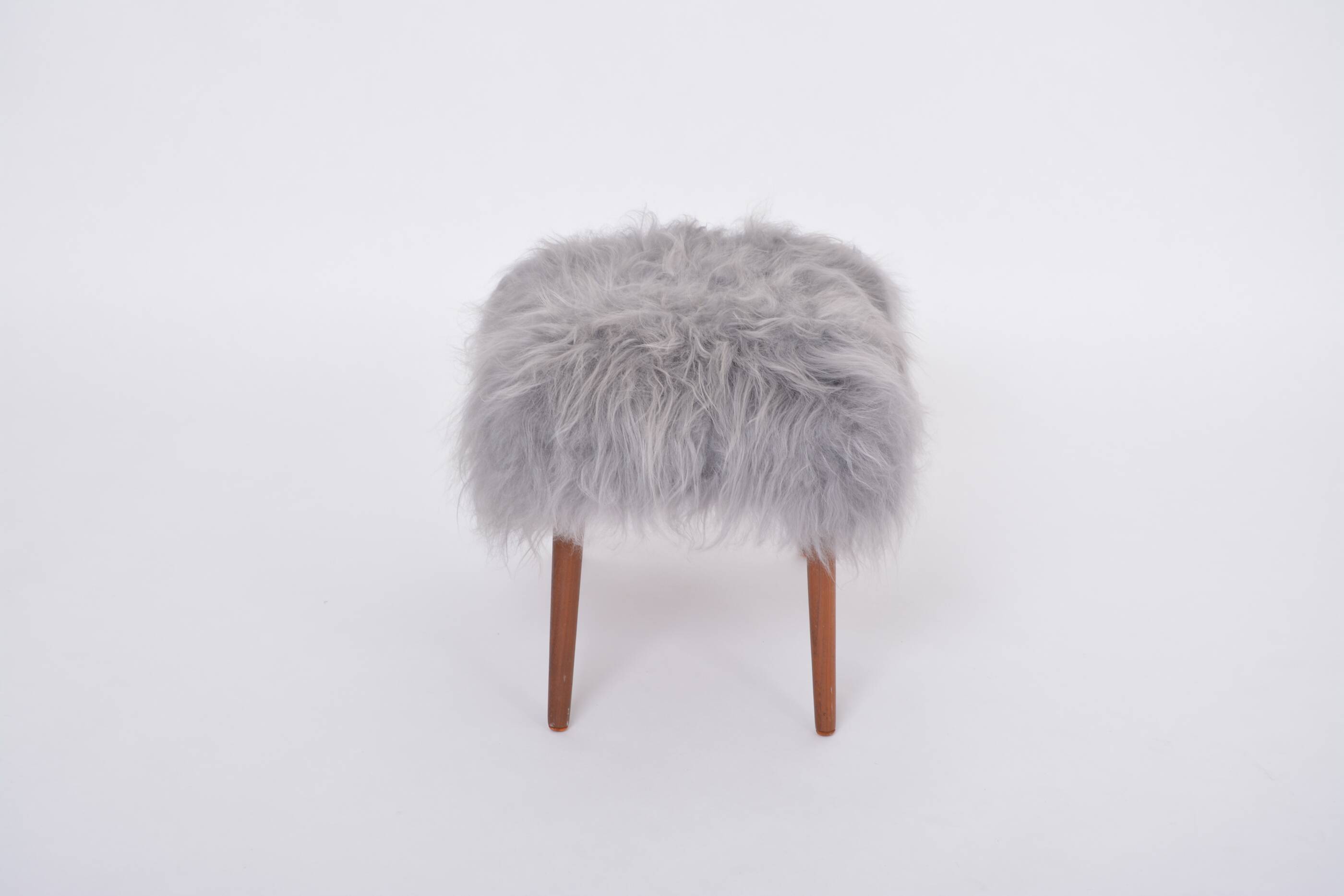 Danish Mid-century Modern stool reupholstered in grey sheep skin