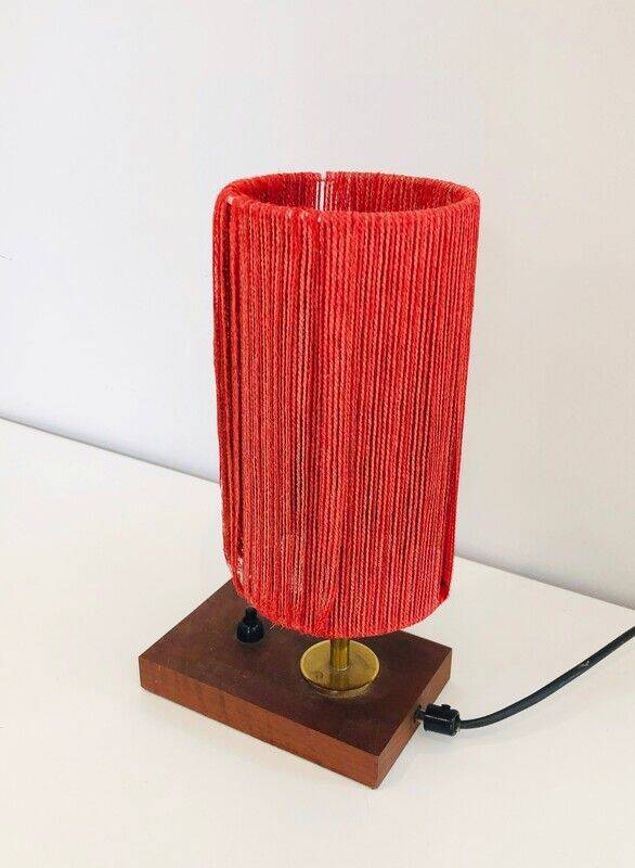 Small lamp made of wood, brass, and wool.