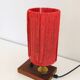 Small lamp made of wood, brass, and wool.
