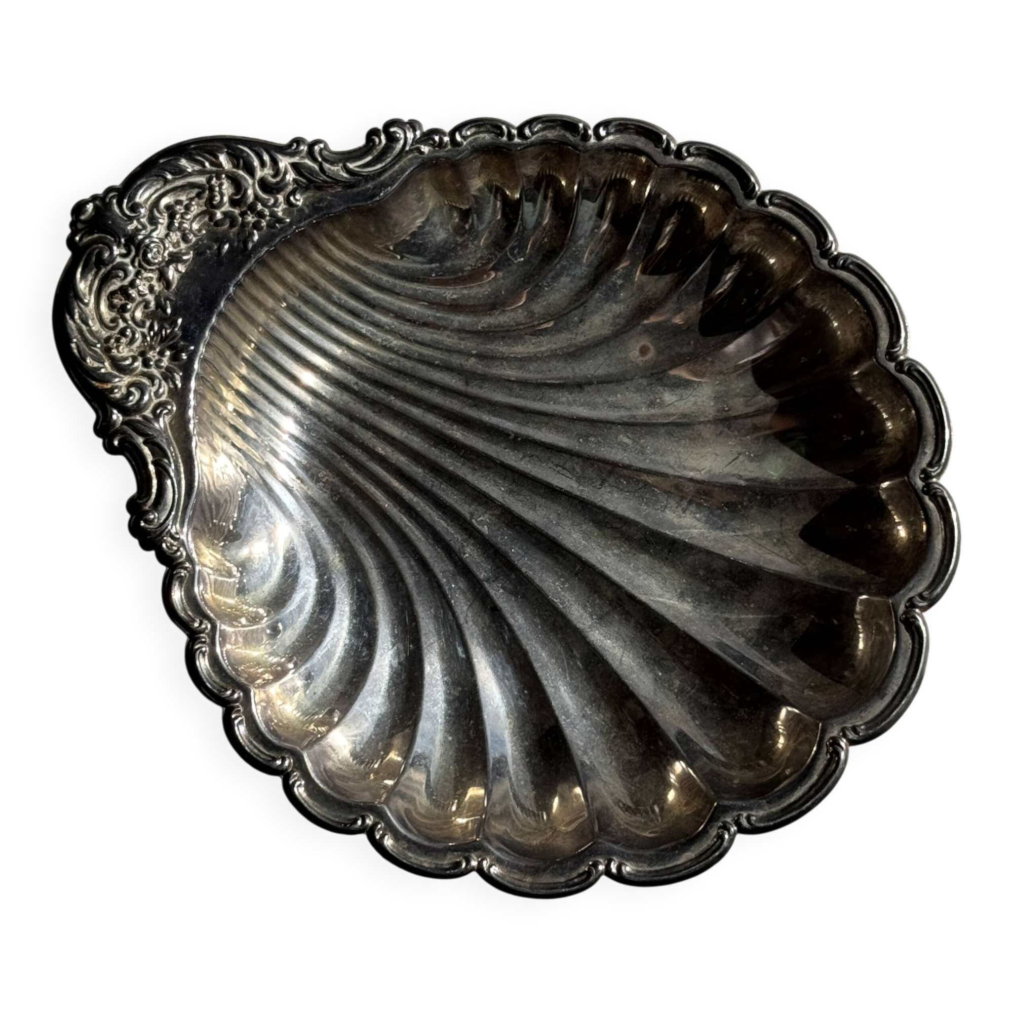 Large antique silver-plated bowl in the shape of a shell.