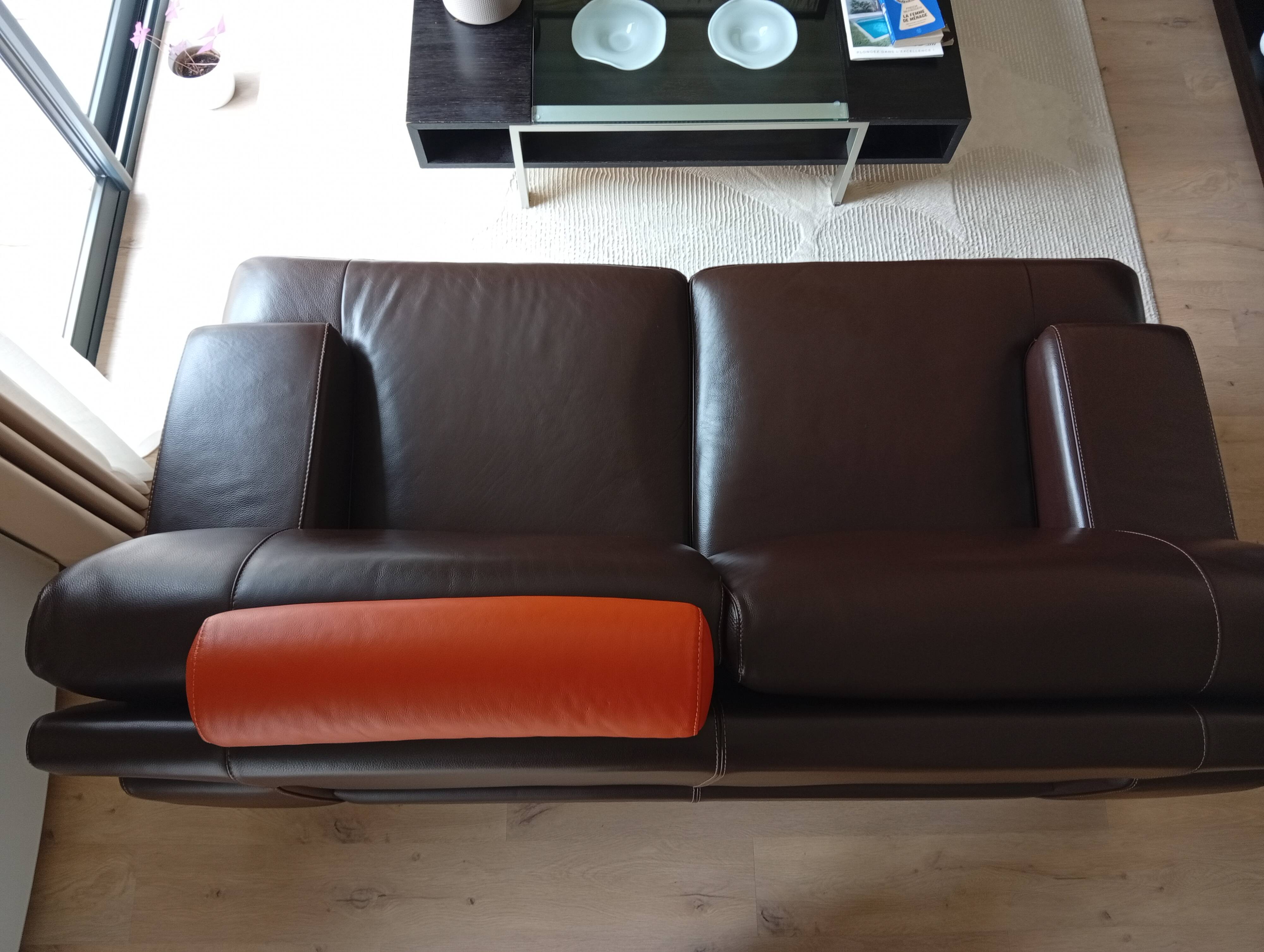 Two brown leather Crozatier two-and-a-half-seater sofas.