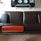 Two brown leather Crozatier two-and-a-half-seater sofas.