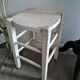 Vintage wooden stool with white peeling paint