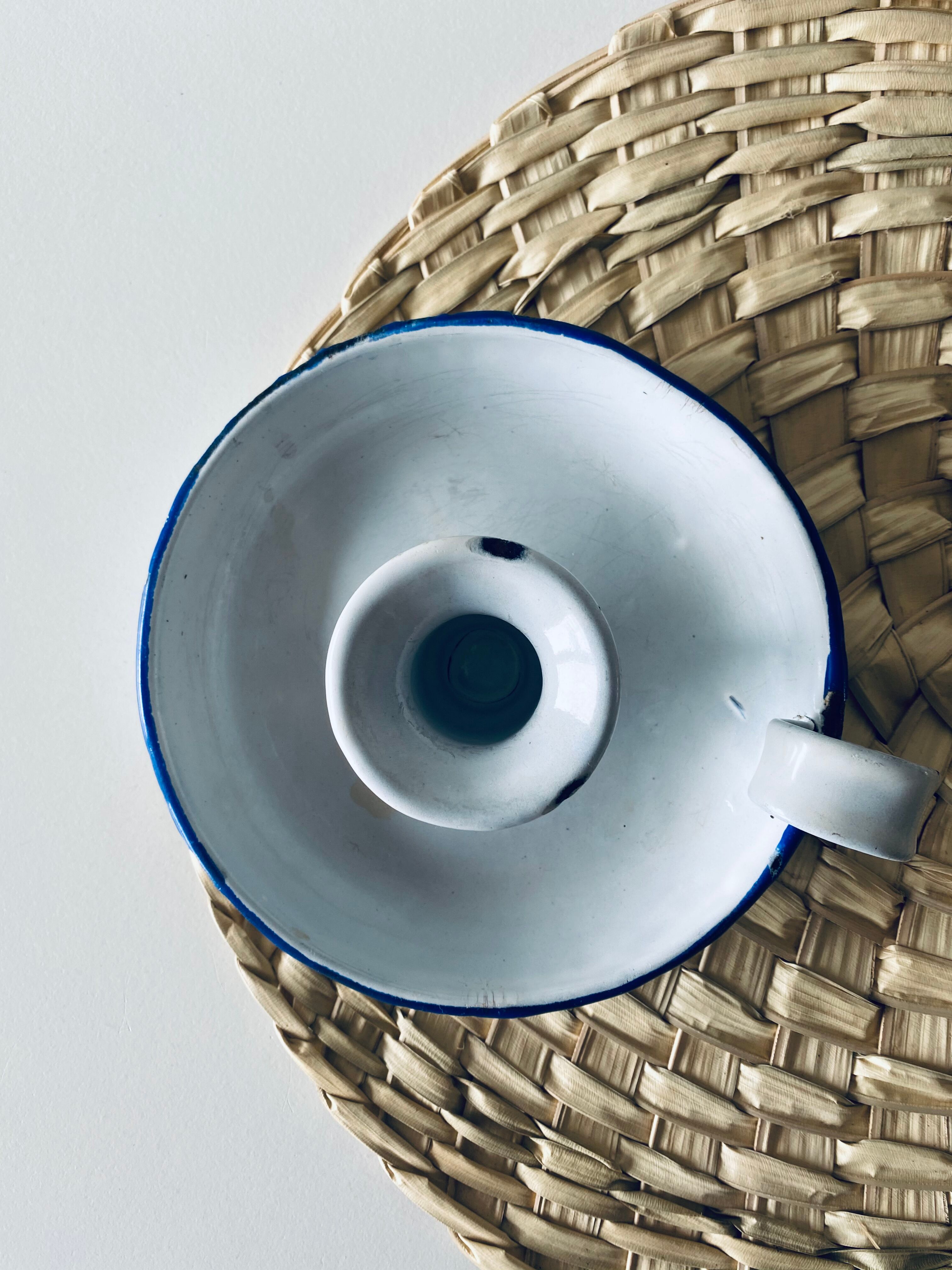 Old enamelled metal candlestick