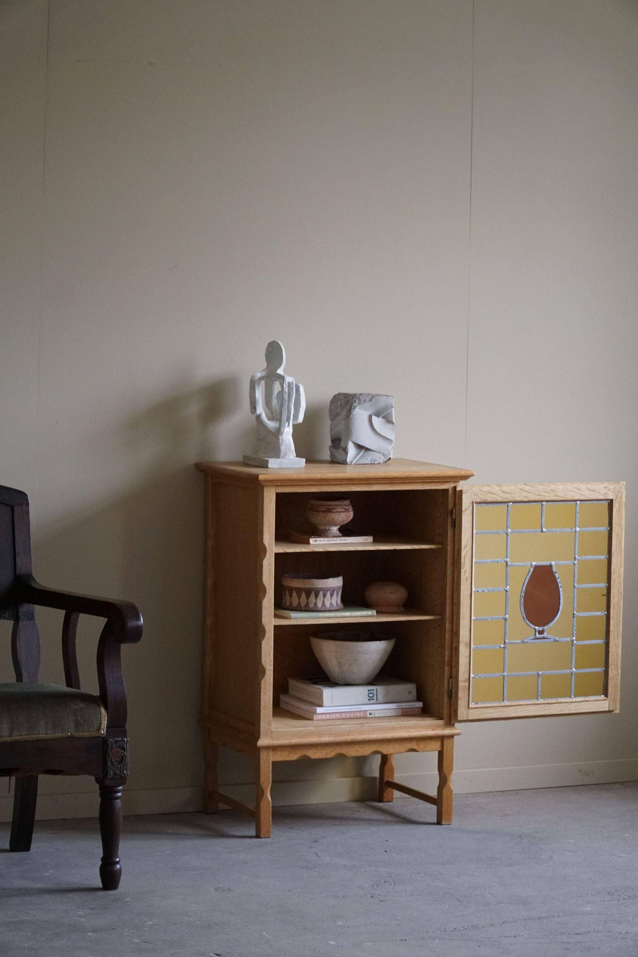 Scandinavian wardrobe in natural oak with a glass front.