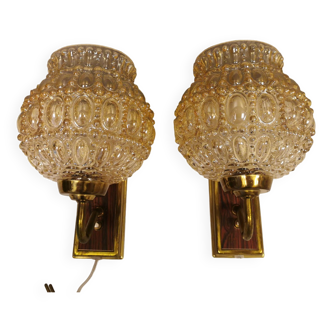 A set of wall lights, 1970s, in metal, brass, rosewood look and with large bubble glass shades