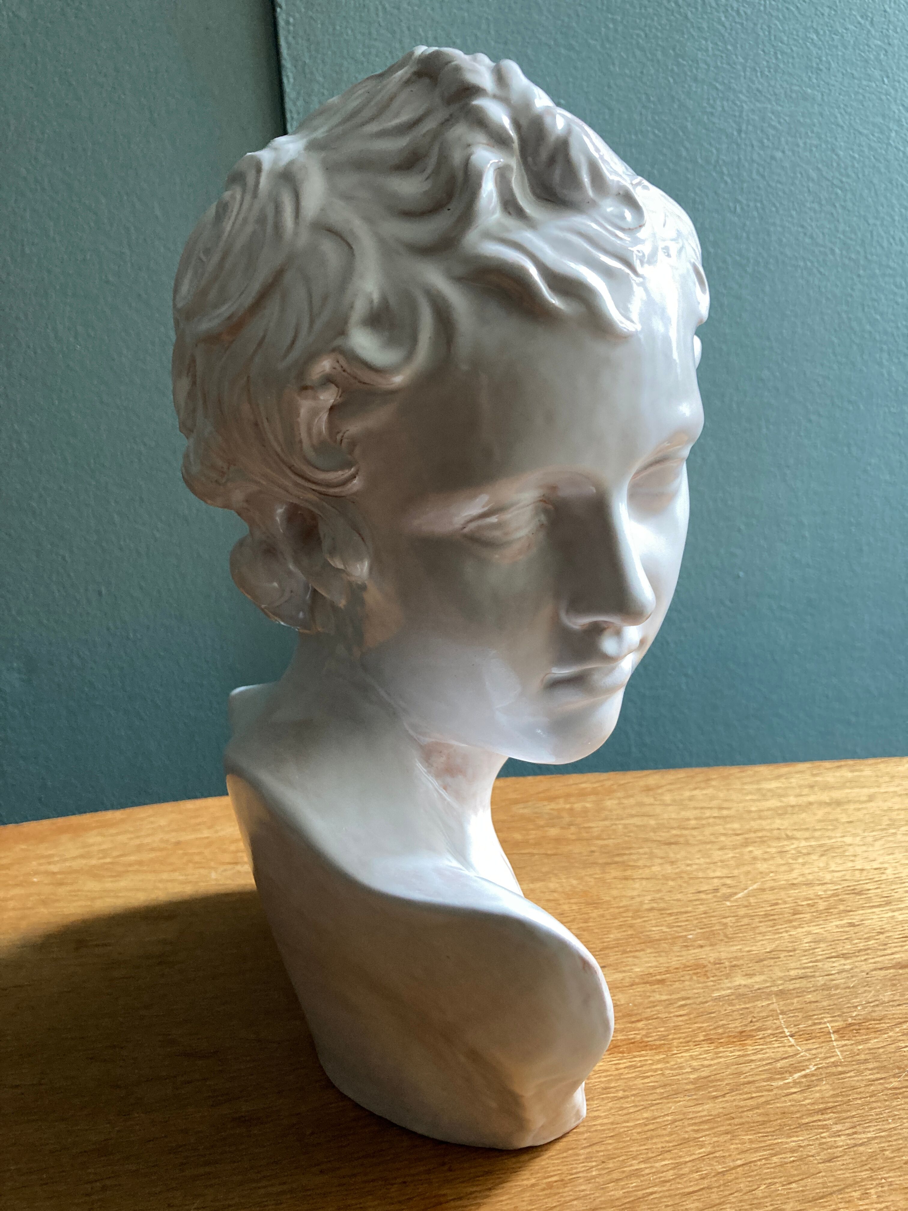 White enamelled terracotta Eros bust