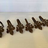 Six metal fleur-de-lys hooks