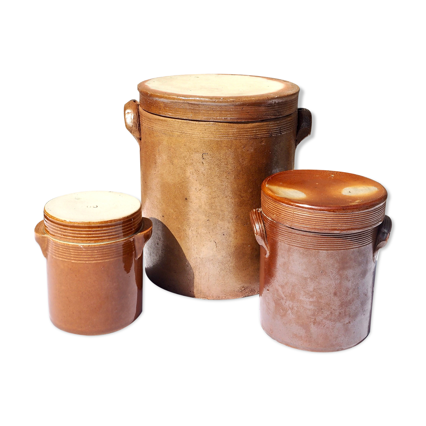Trio of stoneware pots with lids