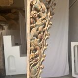 Indonesian construction element in carved wood with intertwined plant motifs mounted on a base (fri