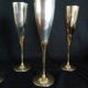 Lot of 12 silver metal flutes on brass stand