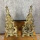 pair of Empire period dolphin firedogs in gilded bronze