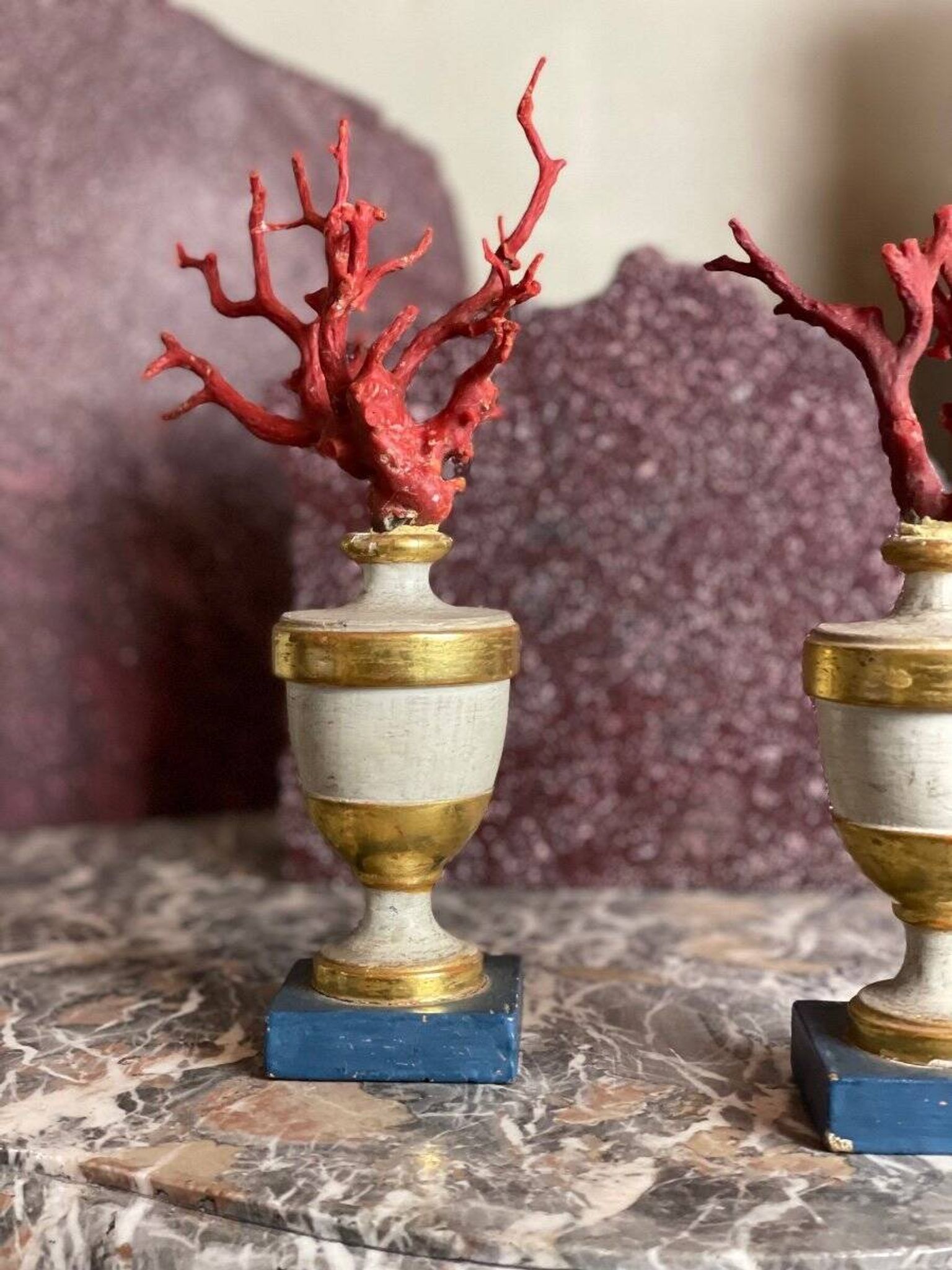 Pair of red corals on gilded and blue wooden bases
